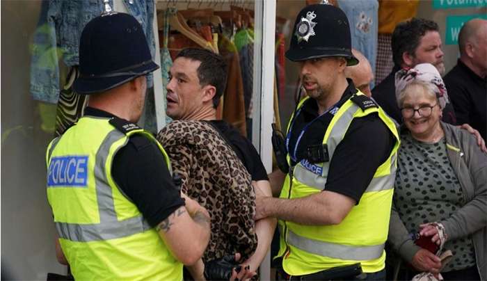 A man is detained by police officers during a protest in Nottingham, England Market Square on Saturday, Aug. 3, 2024, following Monday's stabbing attacks in Southport, in which three young children were killed. (Jacob King/PA via AP) (Jacob King/PA via AP)